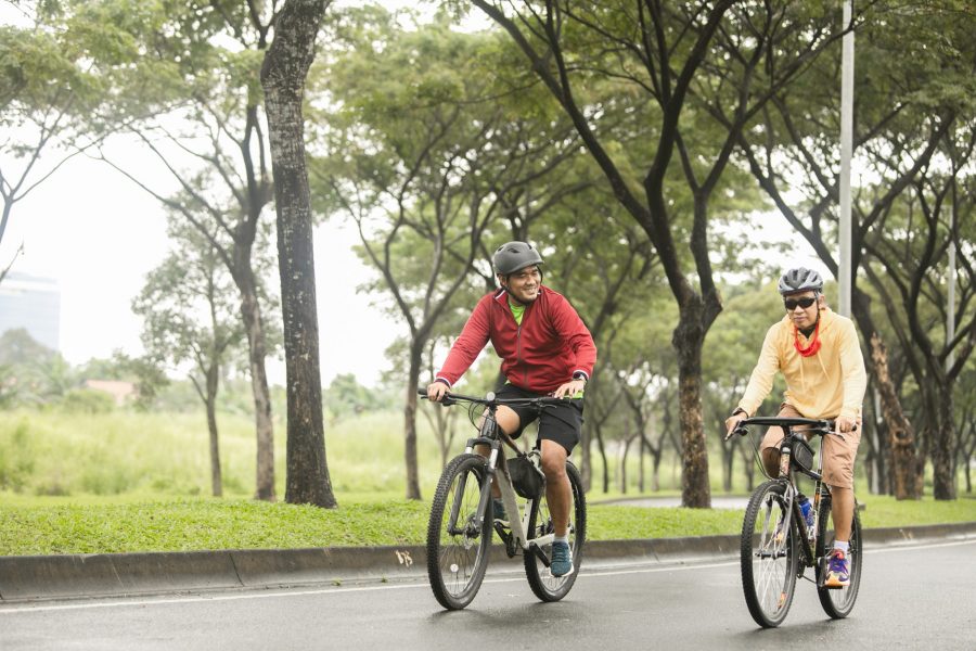 Father and son cycling on the street together